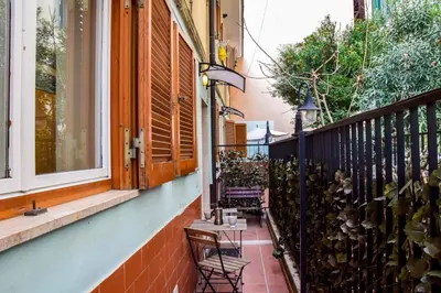 a balcony with a bench and a fence at St. Peter Sweets in Rome