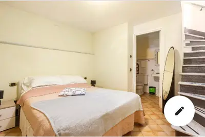 a white bedroom with a bed and a bathroom at 3C Domus St Peter Roma Centro 