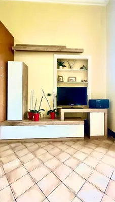 a living room with a television and a tiled floor at 3C Domus St Peter Roma Centro 