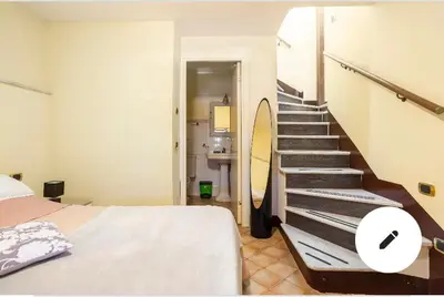 a bedroom with a staircase with a bed and a mirror at 3C Domus St Peter Roma Centro 