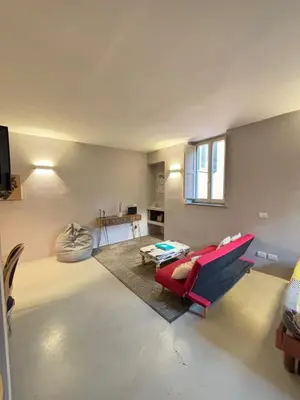 a living room with a red couch and a table at La casa di zoe in Rome