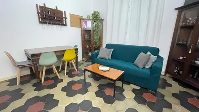 a living room with a blue couch and a table at Da Naya all' Appia Antica in Rome