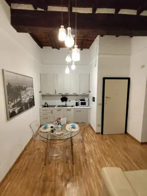 a living room with a table and a kitchen at Bijoux de Rome Navona Luxury Apartment in Rome