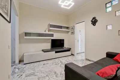 a living room with a couch and a television at Vatican's Apartment in Rome