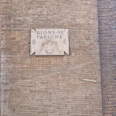 a sign on the side of a brick building at vacanze romane in Rome