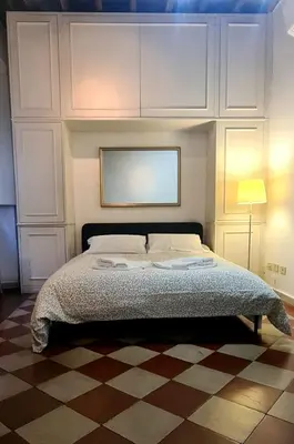 a bedroom with a large bed with white cabinets at vacanze romane in Rome