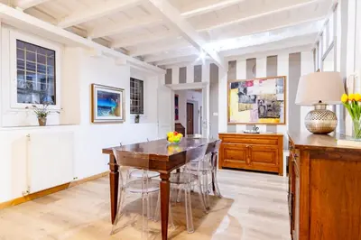 a dining room with a wooden table and chairs at Elegantis Monti Suite Apartment in Rome