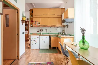a small kitchen with a table and a vase at Bright Loft Rome City Center in Rome