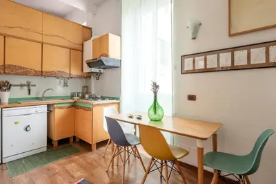 a small kitchen with a wooden table and chairs at Bright Loft Rome City Center in Rome
