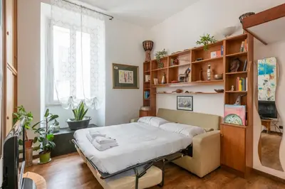 a bedroom with a bed and a book shelf at Bright Loft Rome City Center in Rome