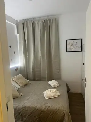 a bedroom with two beds and a window at Casa Roma in Rome