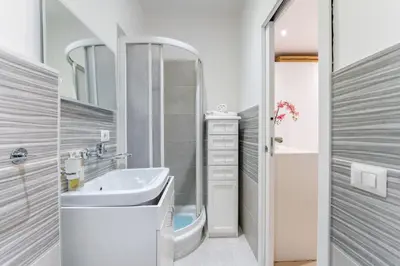 a bathroom with a sink and a mirror at Silver Dream Cornelia, Elegant Apt with Car Park in Rome