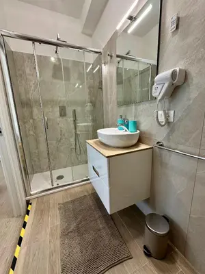 a bathroom with a sink and a shower at Monti Tiburtini Roma Guest House in Rome