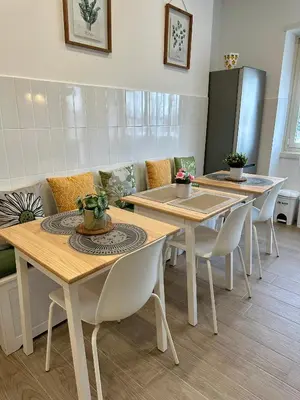 a dining room with two tables and chairs at Monti Tiburtini Roma Guest House in Rome