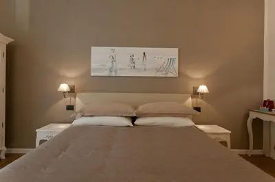 a bedroom with a large bed with two lamps at Rome Eternal City in Rome