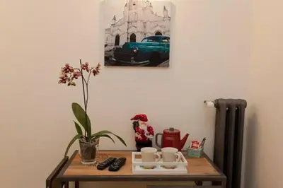a table with a plant and a picture on the wall at Rome Eternal City in Rome