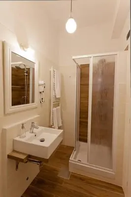 a white bathroom with a sink and a shower at Rome Eternal City in Rome