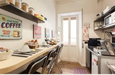 a kitchen with a long counter with chairs in it at Rome Eternal City in Rome