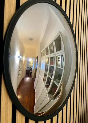 a mirror on a wall with a staircase in a room at Appartamento luminoso con giardino in Rome