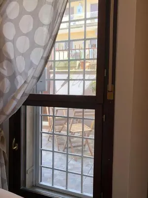 an open door with a view of a building at Appartamento luminoso con giardino in Rome