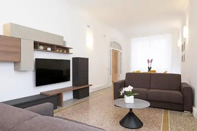 a living room with a couch and a television at LCGrandTour Donatello in Rome