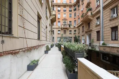 a sidewalk in a city with buildings and plants at LCGrandTour Donatello in Rome