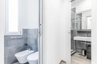 a bathroom with a toilet and a sink at The Trastevere Apartment in Rome