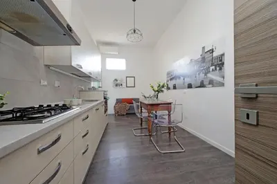 a kitchen with a stove and a table in it at St Peter Giant Apartment in Rome
