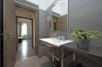 a bathroom with a sink and a mirror at St Peter Giant Apartment in Rome