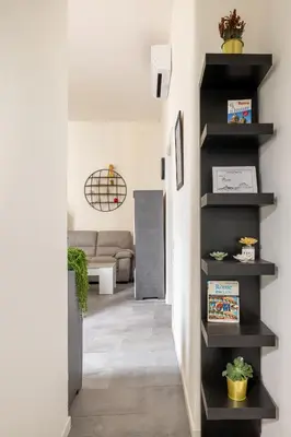 a hallway with black shelves in a living room at ARGILLA PLACE Large apartment close to Saint Peter Basilica in Rome