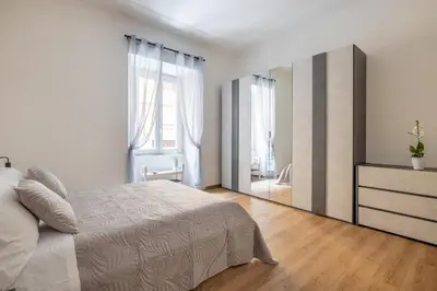 a bedroom with a bed and a large mirror at ARGILLA PLACE Large apartment close to Saint Peter Basilica in Rome