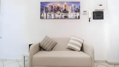 a couch in a living room with a picture on the wall at Elegantis Giolitti Suite Apartment with Private Balcony in Rome