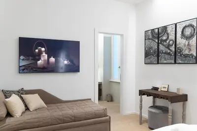 a living room with a couch and a table at ARIOSTO'S Luxury Rooms in Rome