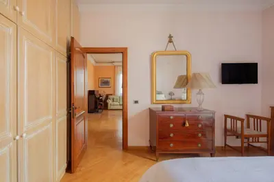 a bedroom with a dresser and a mirror on the wall at Tomas' house Clodio in Rome