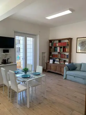 a living room with a table and chairs and a couch at Annalisa Home in Rome