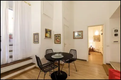 a dining room with a table and chairs at Barberini Exclusive Apartment in Rome