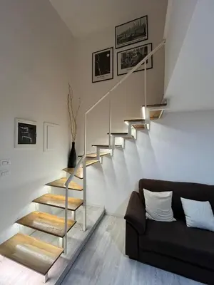 a staircase in a living room with a couch at LaDolcevita - Casa Milvia in Rome