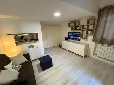 a living room with a couch and a tv at LaDolcevita - Casa Milvia in Rome
