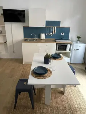 a kitchen with a white table with two plates on it at Suite San Giovanni in Rome