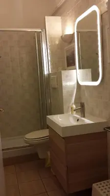 a bathroom with a sink and a toilet and a mirror at Romeathome146 - Monti in Rome