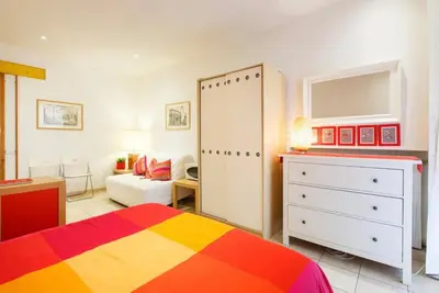 a bedroom with a bed and a dresser and a room at Romeathome146 - Monti in Rome