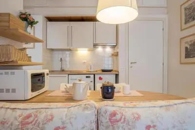a kitchen with a table with two chairs and a microwave at Romeathome146 - Monti in Rome