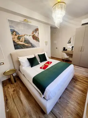 a bedroom with a bed and a table and chairs at Golden Palace Luxury Guest House in Rome