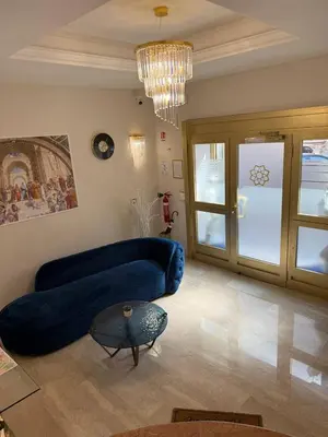 a living room with a blue couch and a mirror at Golden Palace Luxury Guest House in Rome