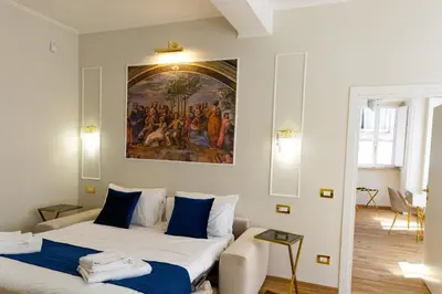 a living room with a couch and a painting on the wall at Golden Palace Luxury Guest House in Rome