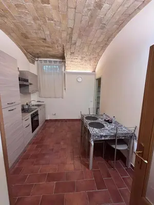 a kitchen with a table in a room at Sophia s Home in Rome