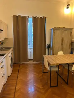 a kitchen with a table and chairs in a kitchen at loft 06 - new opening in Rome