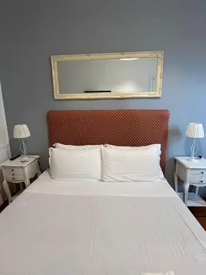 a bedroom with a bed with a mirror above it at loft 06 - new opening in Rome