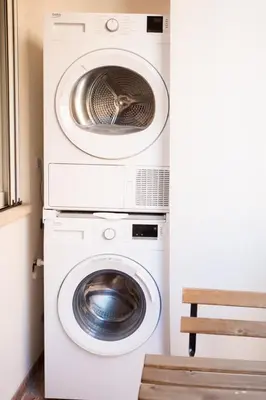 two washing machines and a dryer in a room at RoomApartment Roma in Rome