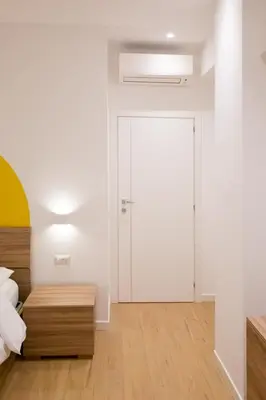 a bedroom with a bed and a sliding door at RoomApartment Roma in Rome